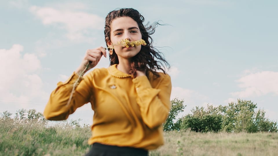 Woman smelling a flower